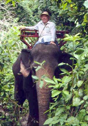 Jungle John in Thailand exploring for new species of plants on his favorite elephant.